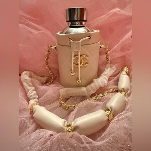 CHANEL Cream Quilted Mini Drawstring Bucket Bag with Gold water bottle